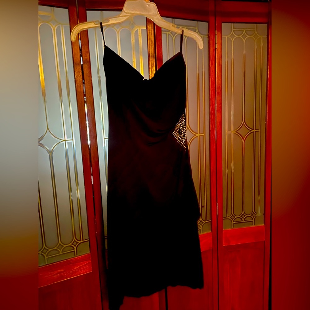 Mini black strapless dress with Joel design on one side.